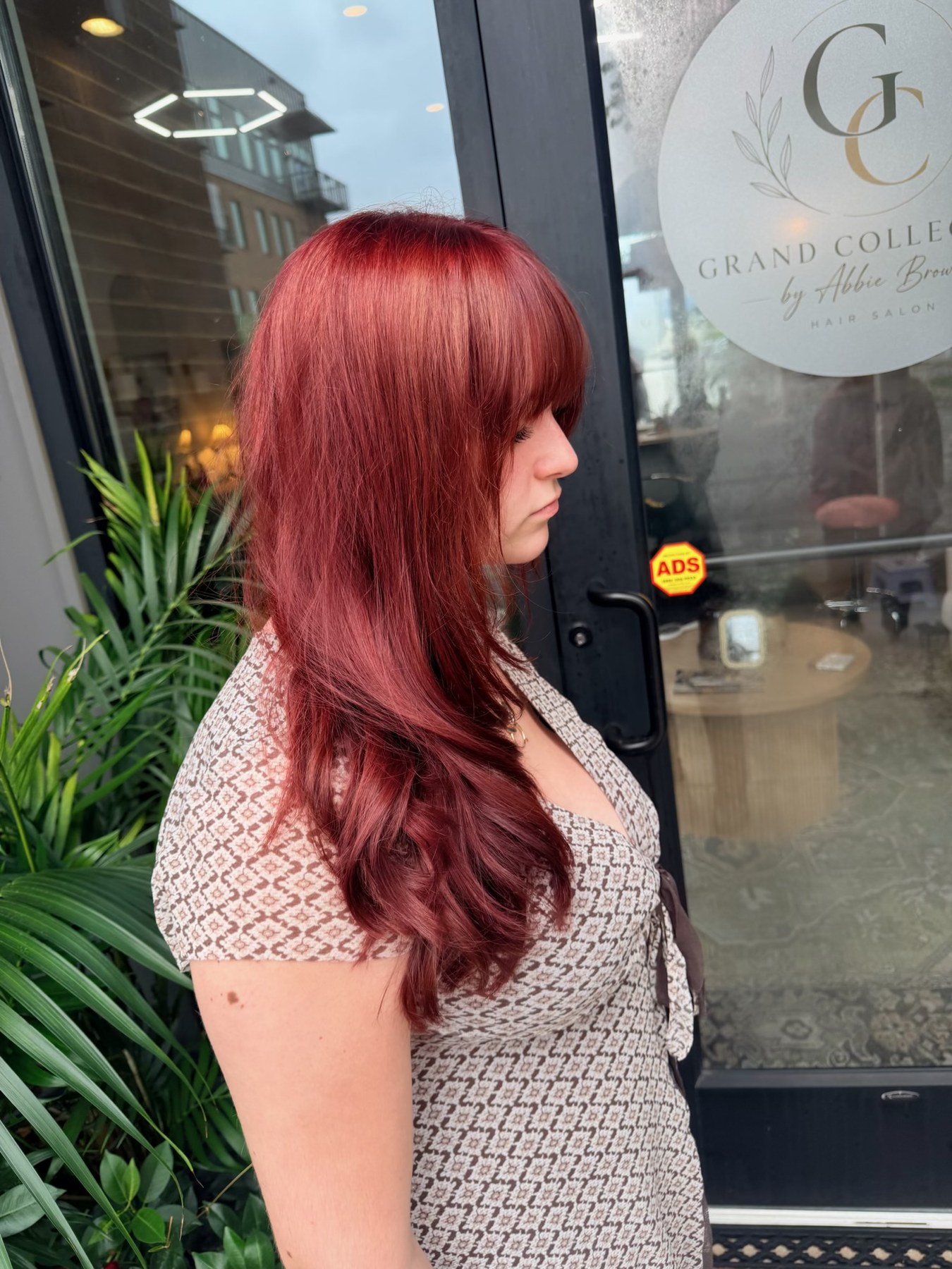 Rich red layered haircut by Dakota Coone