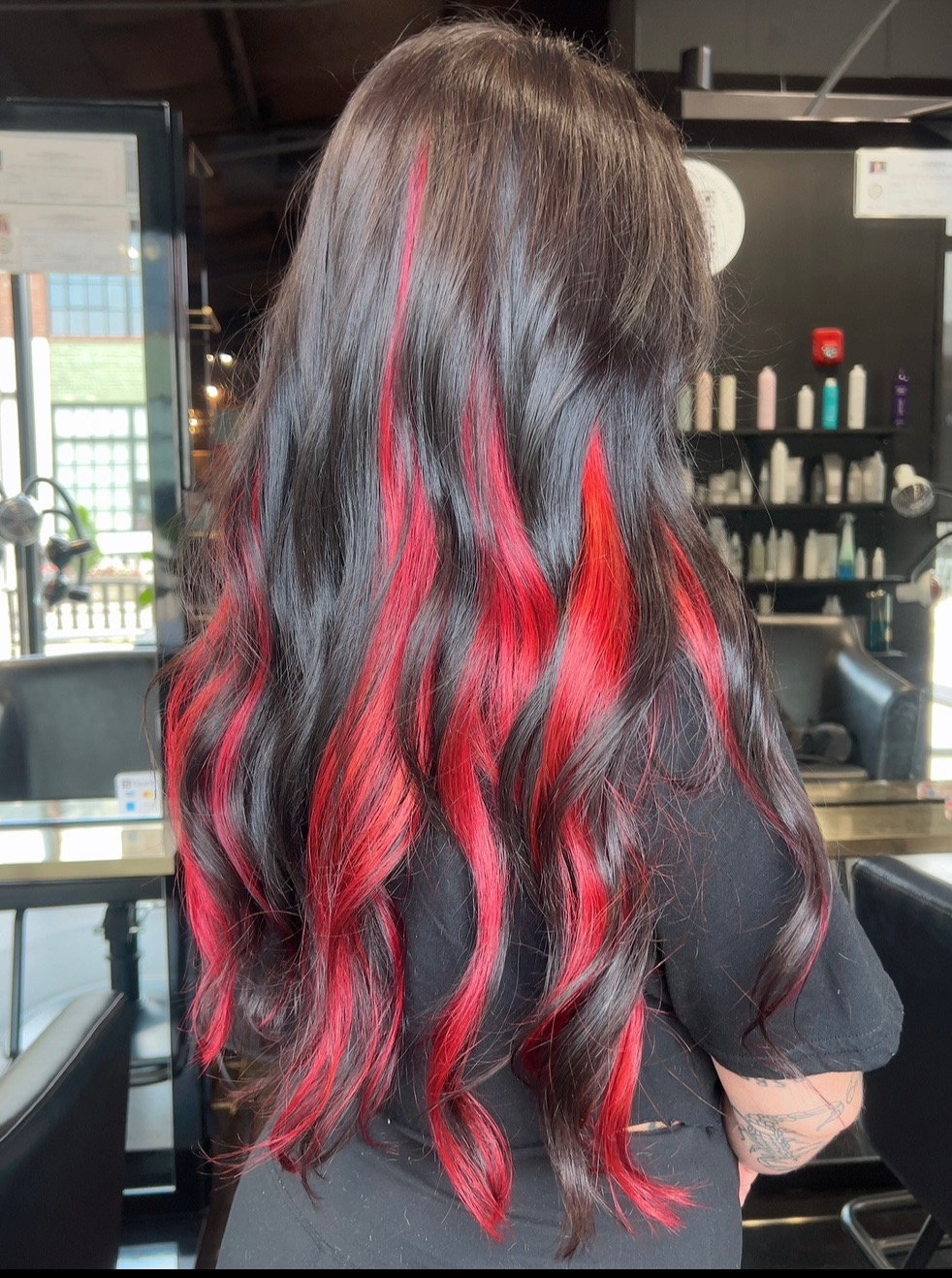 Dimensional dark hair with red fashion color by Emilee Anderson