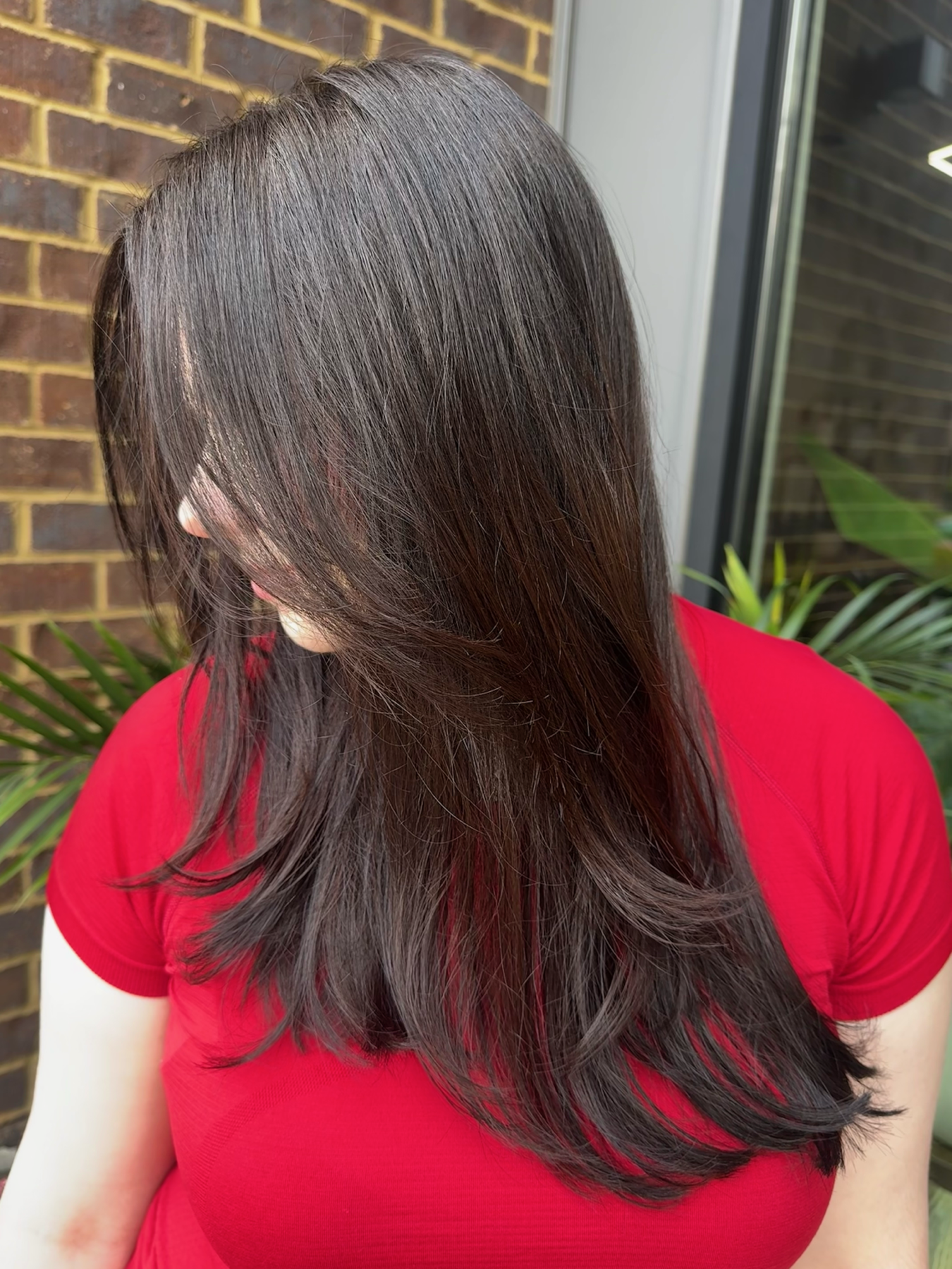 Long brunette layered haircut by Reshae Simmons